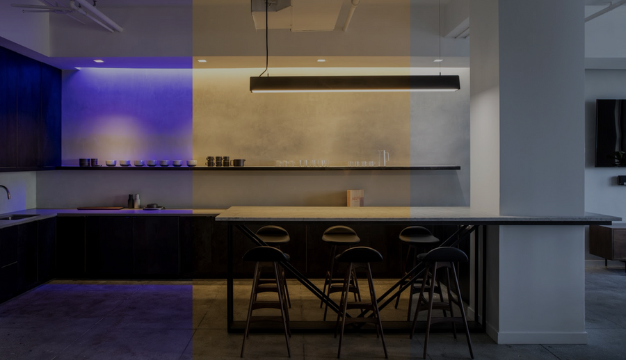 A kitchen is illuminated with different color lights through Ketra lighting control.