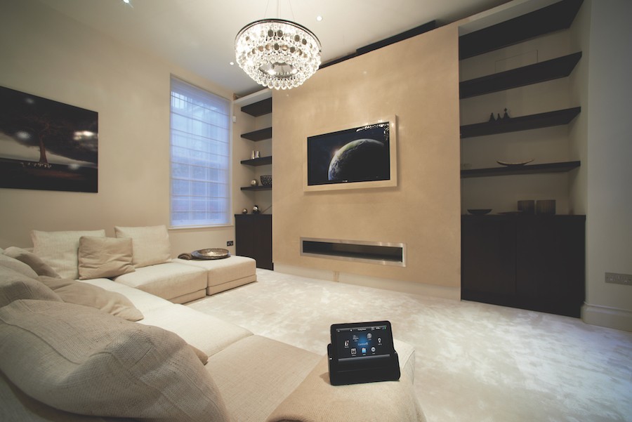 A luxury living room with a Control4 system control on the couch.
