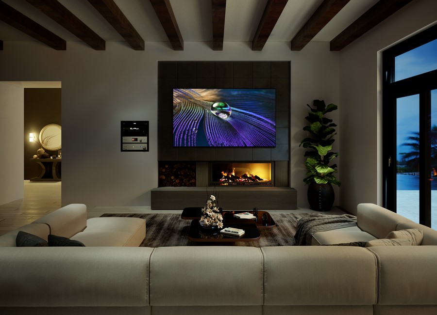 A living room with a Sony 100-inch TV above a fireplace.