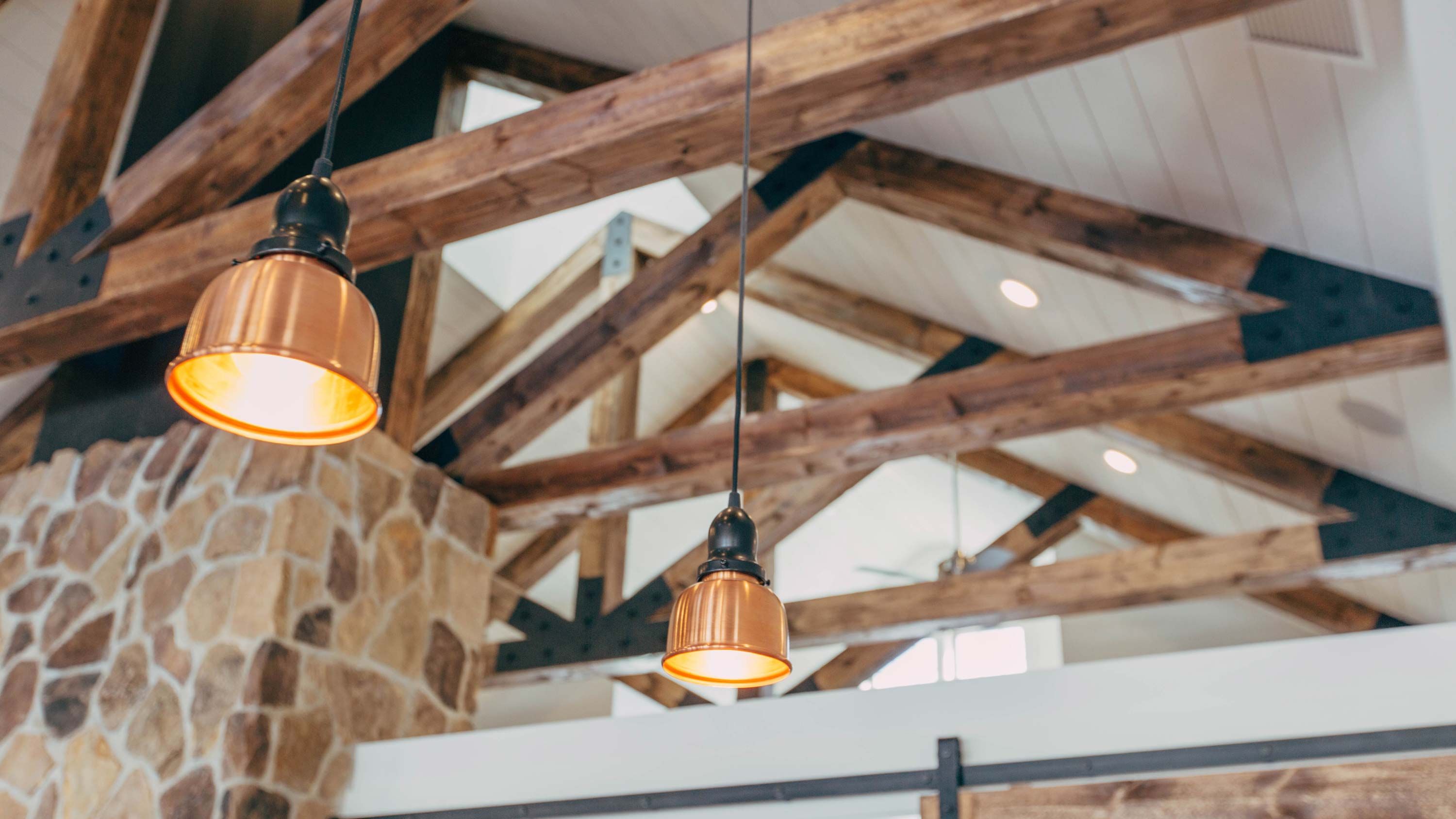 View of wooden beams on ceiling with white shiplap